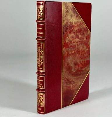 the book is red and gold with gold trimmings on it