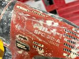 a red and black drill in a red tool box