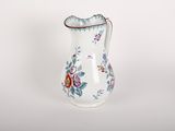 a white vase with a floral design on it