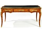 a desk with a black top and gold trimmings