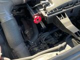 a close up of a car ' s engine with the hood open