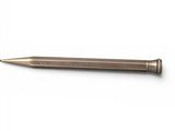 a close up of a metal pen on a white surface