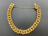 a gold necklace with a chain that is attached to it