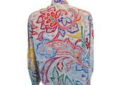 a close up of a white shirt with colorful designs on it