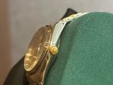 a watch sitting on top of a green hat