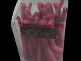 a clear box filled with pink crayons on a black background
