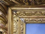 a picture of a gold frame with a picture in it