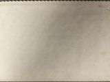a close up of a piece of paper with a scallop edge