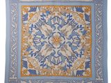 a blue and yellow square scarf with a floral design