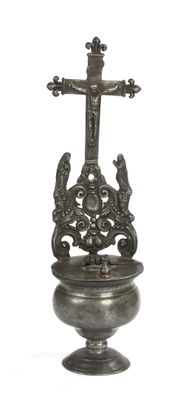 a silver urn with a cross on top of it