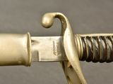 a close up of a sword with a gold handle