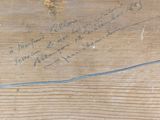 a piece of wood that has writing on it