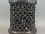 an image of a black vase with holes in it