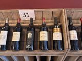 several bottles of wine are in a wooden crate on a table