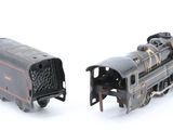 two toy trains sitting side by side on a white surface