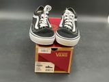 pair of black and white vans sneakers sitting on top of a box