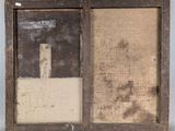an old picture frame with a picture of a building in it