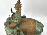 statue of a man riding an elephant with a hat on his head