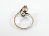 a close up of a silver ring with a diamond in it