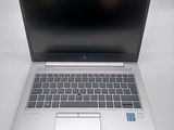 an open laptop computer sitting on top of a white table
