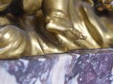 a gold statue of a woman holding a baby