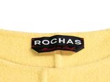 a close up of a yellow coat with a black label on it
