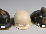 three helmets are lined up in a row on a white surface