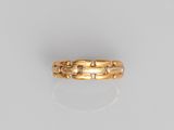 a close up of a gold ring on a white surface
