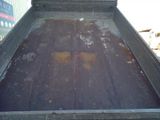an image of a dirty dump truck bed in the back of a truck