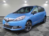 a blue car is parked in a room with a checkered floor