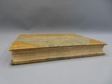 an old book sitting on top of a white table