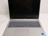 an open laptop computer sitting on top of a white table