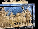 a statue of a horse drawn carriage with a man on it