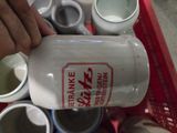 a person pouring milk from a bottle into a container