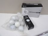 a box of golf balls on a counter next to a box of golf balls