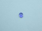 a close up of a blue glass object on a white surface