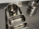 a stainless steel tray with a metal container on it