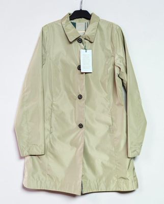 a close up of a jacket hanging on a hanger on a wall