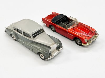 deux voitures jouets assises l'une à côté de l'autre sur une surface blanche