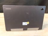 a black laptop with a yellow sticker on it