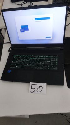 a laptop that is sitting on a table with a price tag on it
