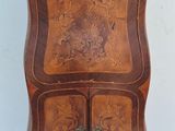a small wooden cabinet with two drawers on it