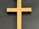 a close up of a cross on a black surface