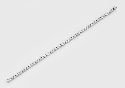 a close up of a silver chain on a white surface