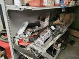 a metal shelf filled with assorted items in a garage