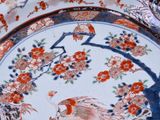 an image of a plate with a bird and flowers on it