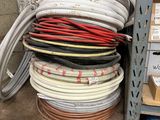 many different types of wires on a shelf in a warehouse