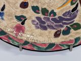 a decorative plate with birds and flowers on it