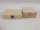 two small wooden boxes with metal handles on a white surface