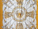 yellow and white square scarf with a gold and silver design